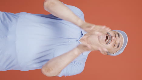 Vertical-video-of-Old-man-clapping-excitedly-to-camera.